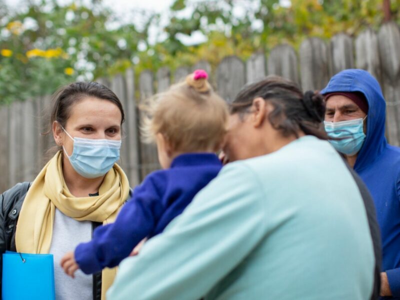 Andreea talking to the young child of a family in Romania