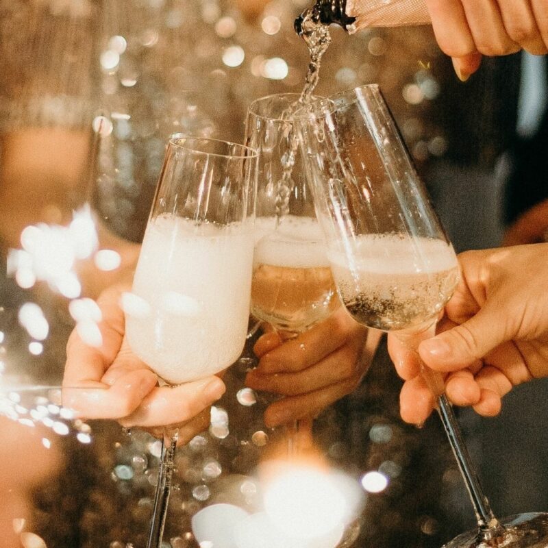 People clinking champagne glasses in celebration