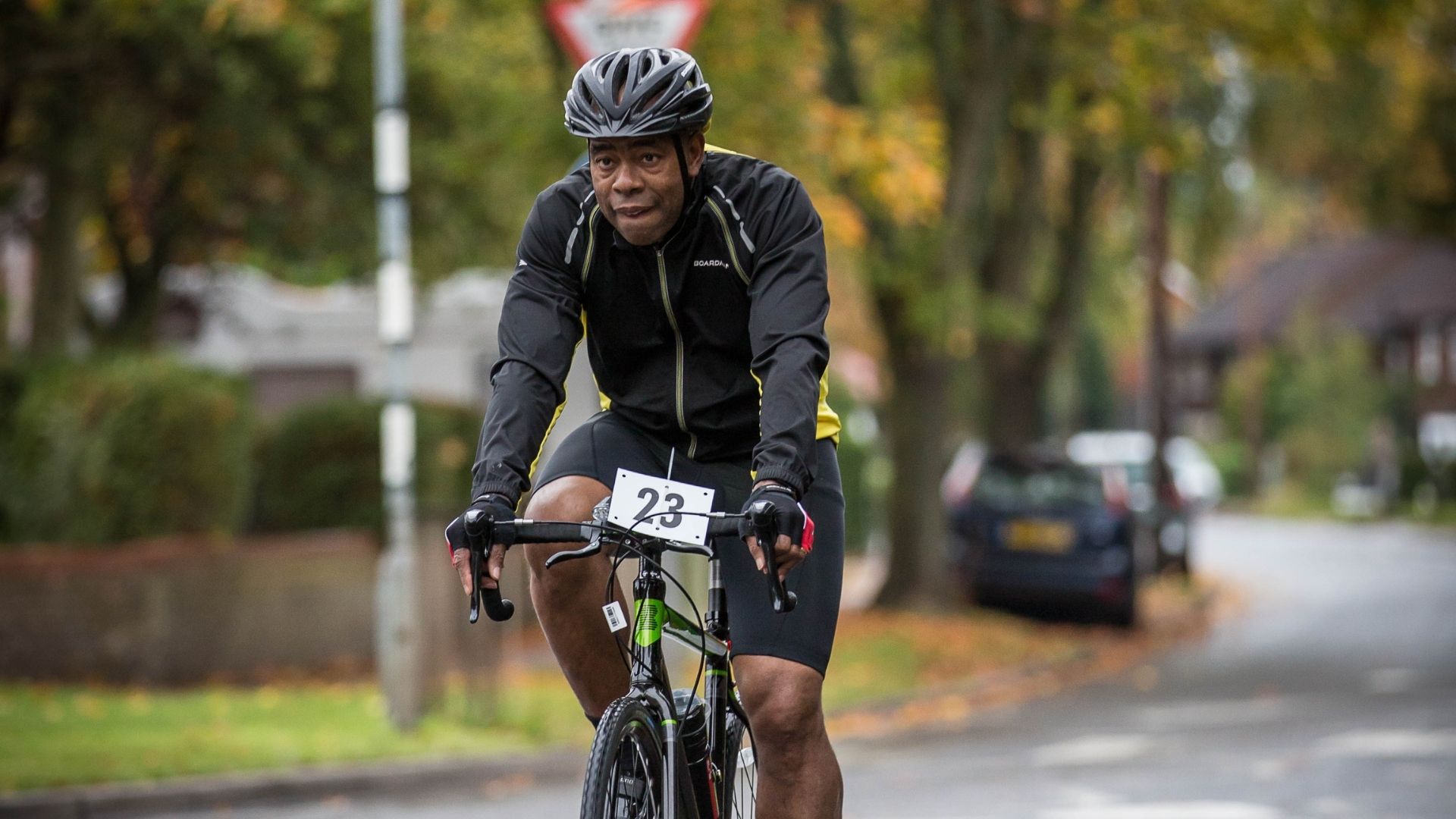 Black male cyclist participating in the St James Place triathlon