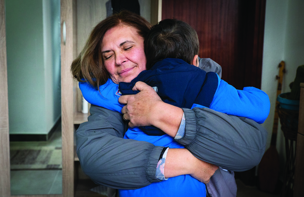 A social worker embracing a child