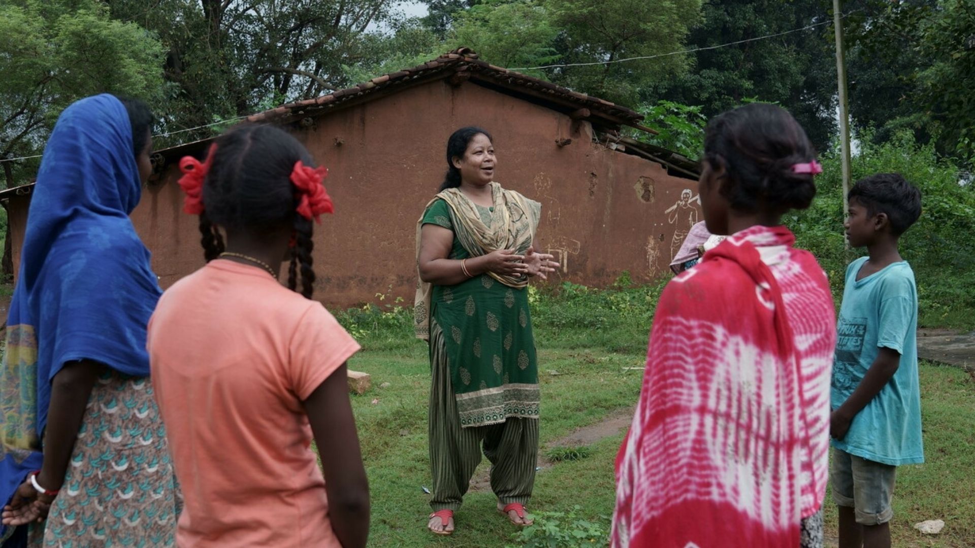 A team member speaking to local women