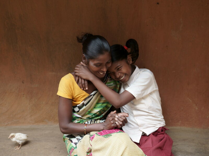 Sonia, one of the children our partners, CINI, have helped, hugging her mother.