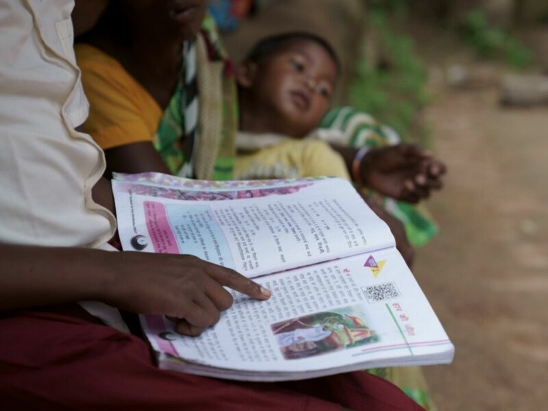 Sonia reading a book. She is able to stay in school thanks to our work, together with CINI