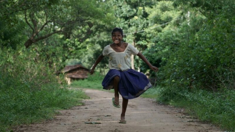 Sonia, who we worked with in India, running and laughing