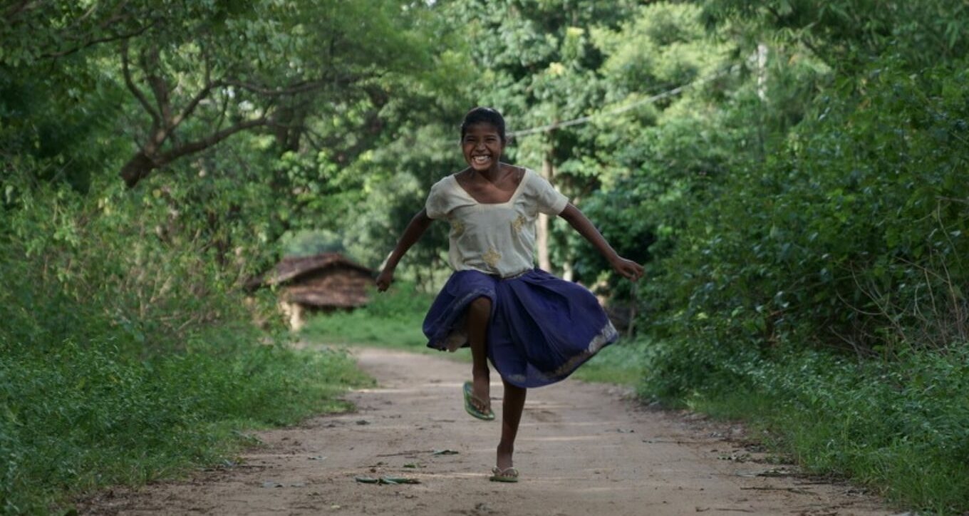 Sonia, who we worked with in India, running and laughing