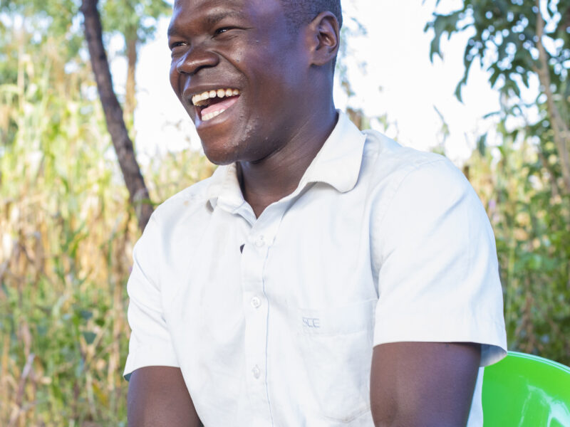 Tom is smiling following Hope and Homes For Children Helping Reunite him with his family in Uganda