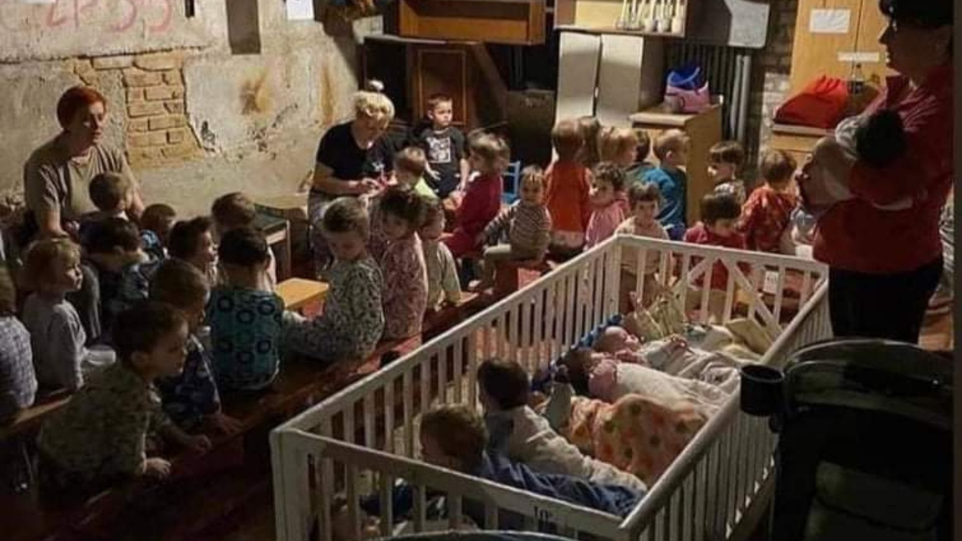 Children sheltering in a basement bomb shelter nursery, Kyiv