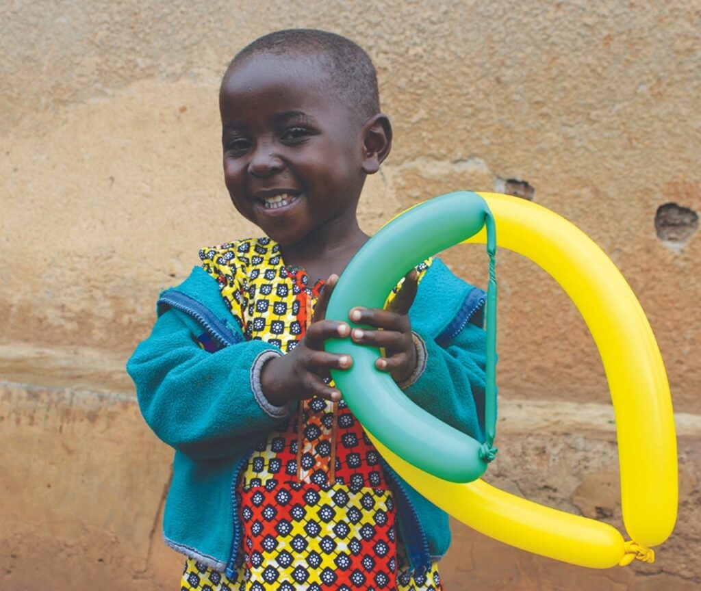 Uwera smiling and holding a balloon