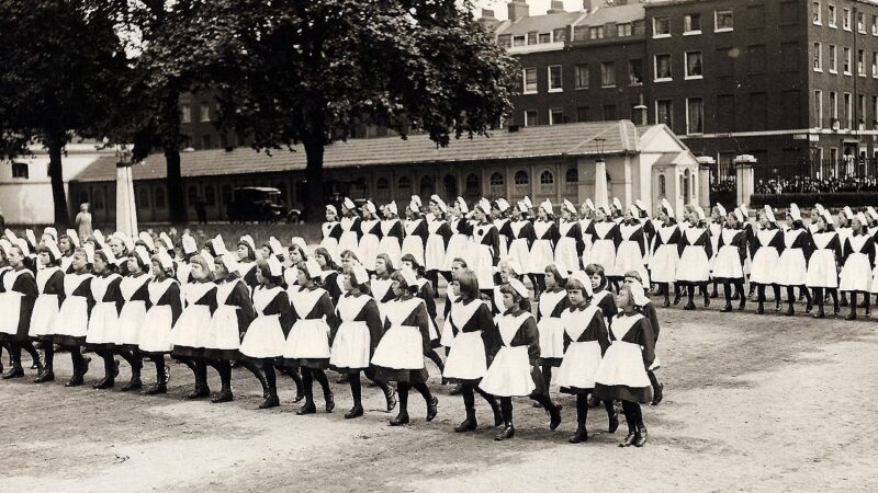 An old photo of foundlings marching in lines at