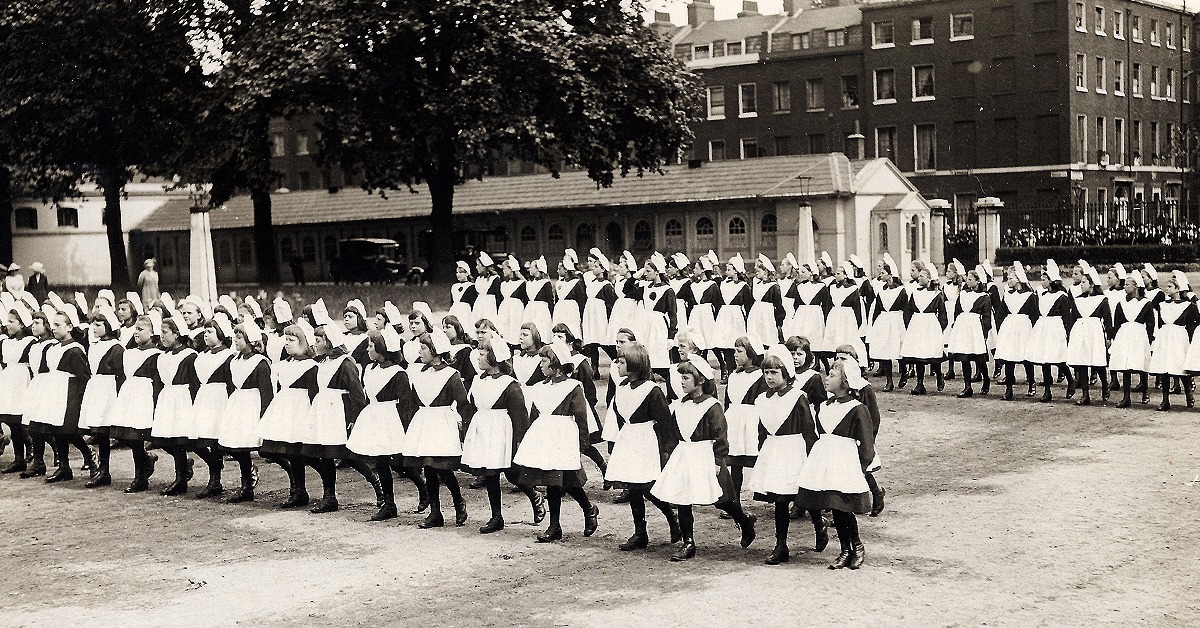 An old photo of foundlings marching in lines at