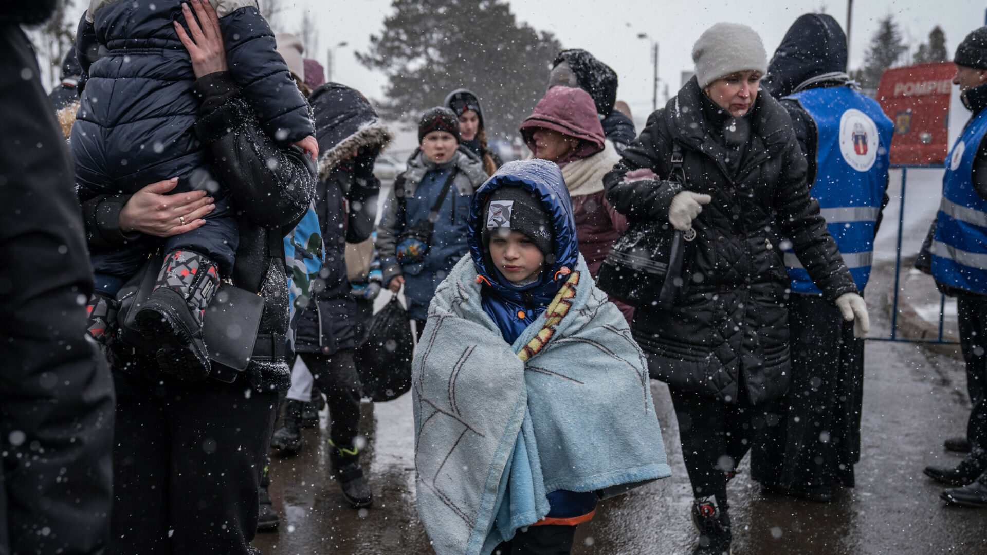 Refugees crossing the border from Romania to Ukraine in bitterly cold snowy weather