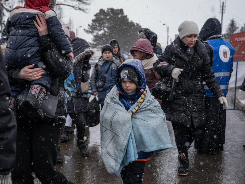 Refugees crossing the border from Romania to Ukraine in bitterly cold snowy weather