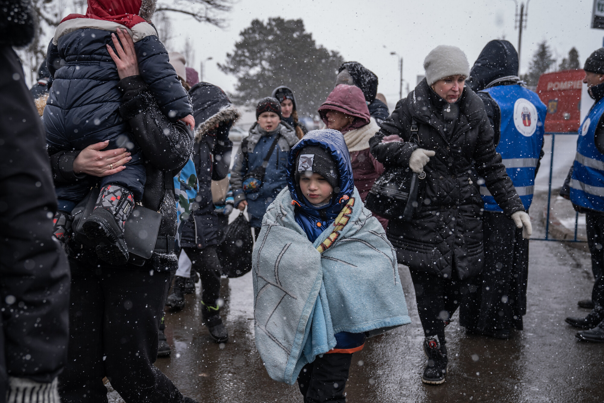 Refugees crossing the border from Romania to Ukraine in bitterly cold snowy weather