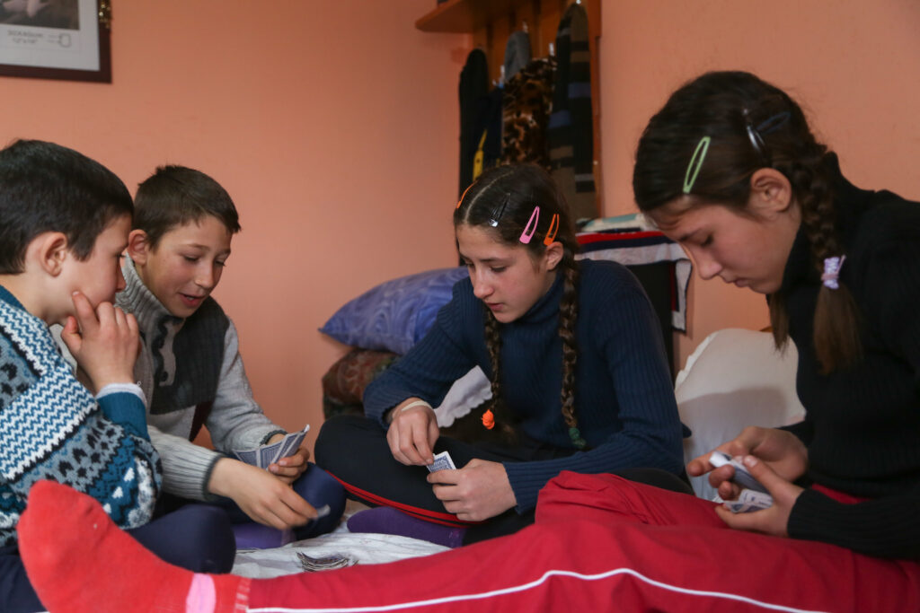 Young children playing cards together