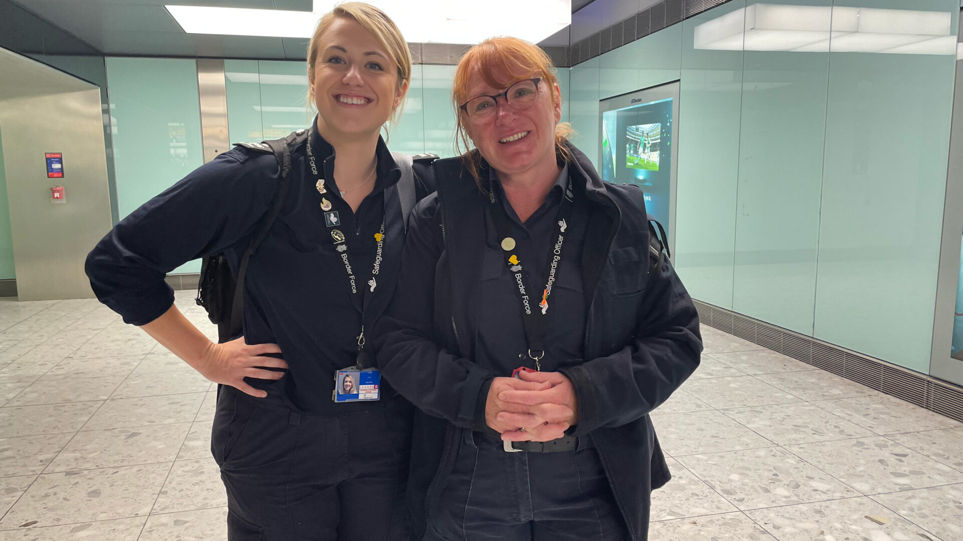 Two uniformed, female border force agents smile at the camera after a successful operation