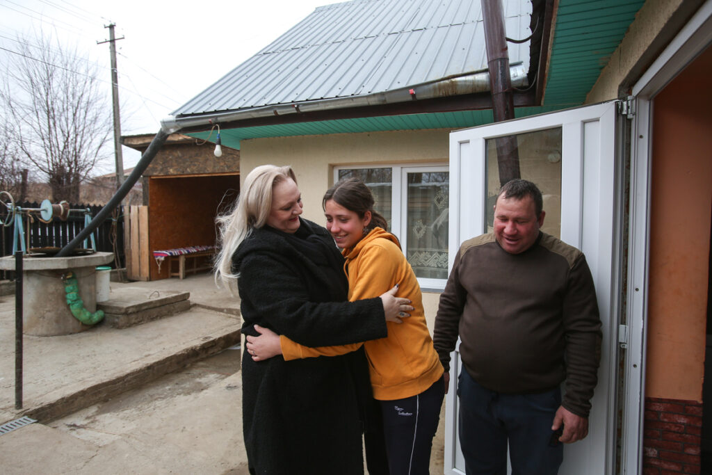 Simona and Alina hugging outside the Vancea family's house