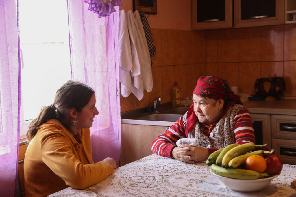 Grandma, Georgeta, speaking to her child, Alina at a kitchen table