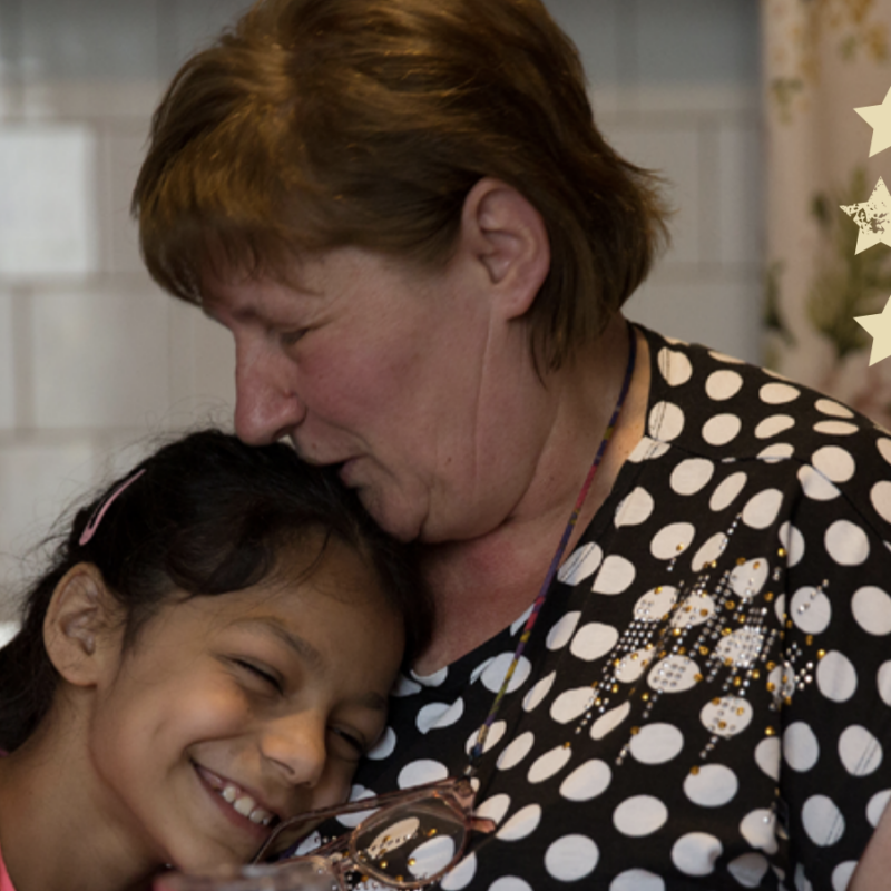 Woman kissing head of young child