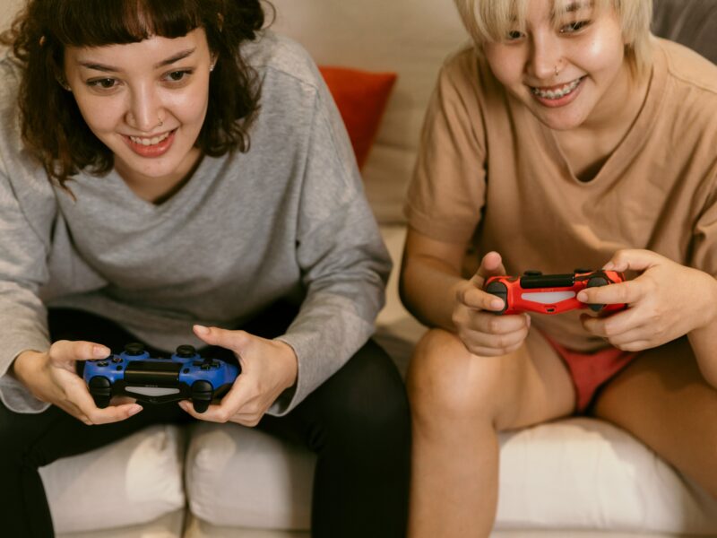 Image: 2 young women playing a game on a Playstation