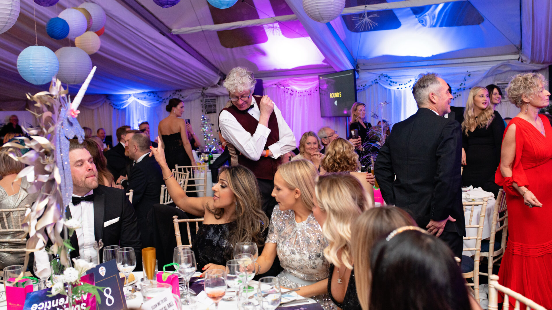 Image of a group of people laughing at a ball