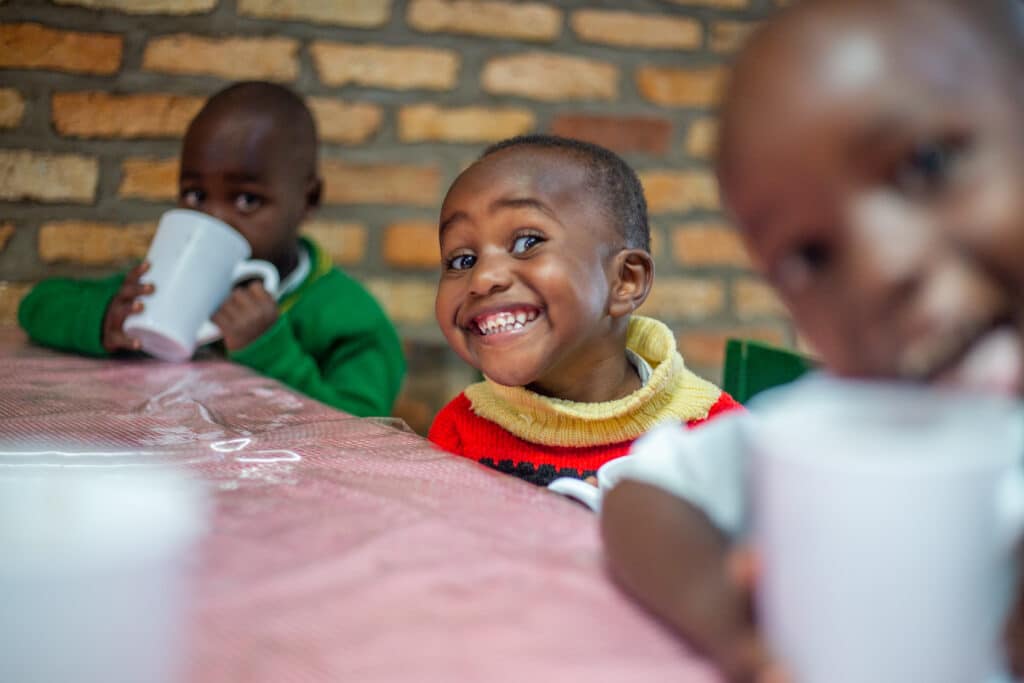 Image is of a young child smiling at camera