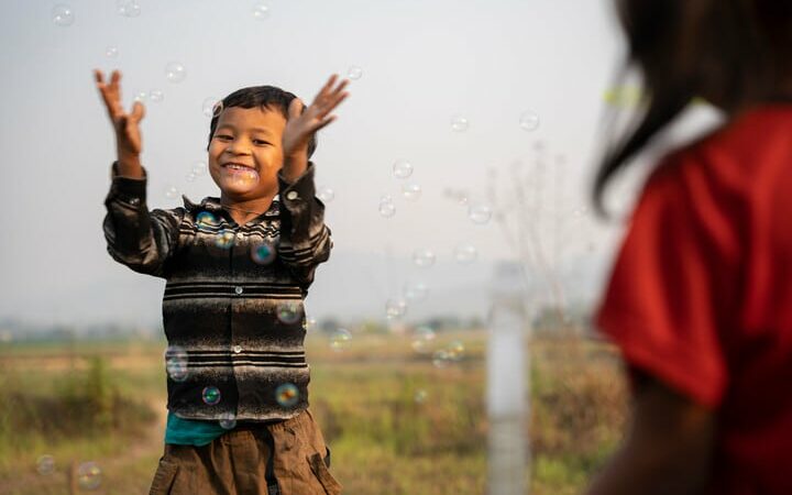 Sunil, who spent two years inside an orphanage, plays with bubbles outside his family home.
