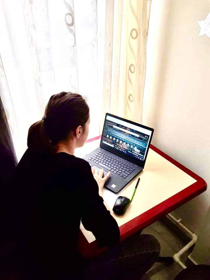 Flavia sits at her laptop