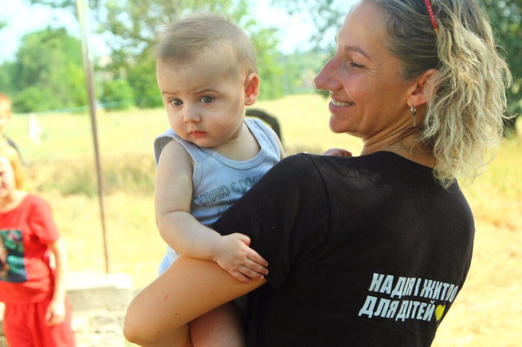 HHC staff member holds a baby