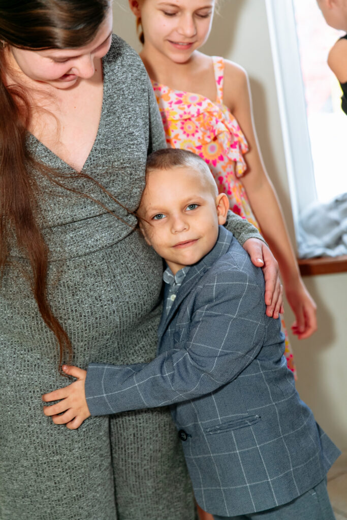 Dmytro hugs Tetiana, his sister.